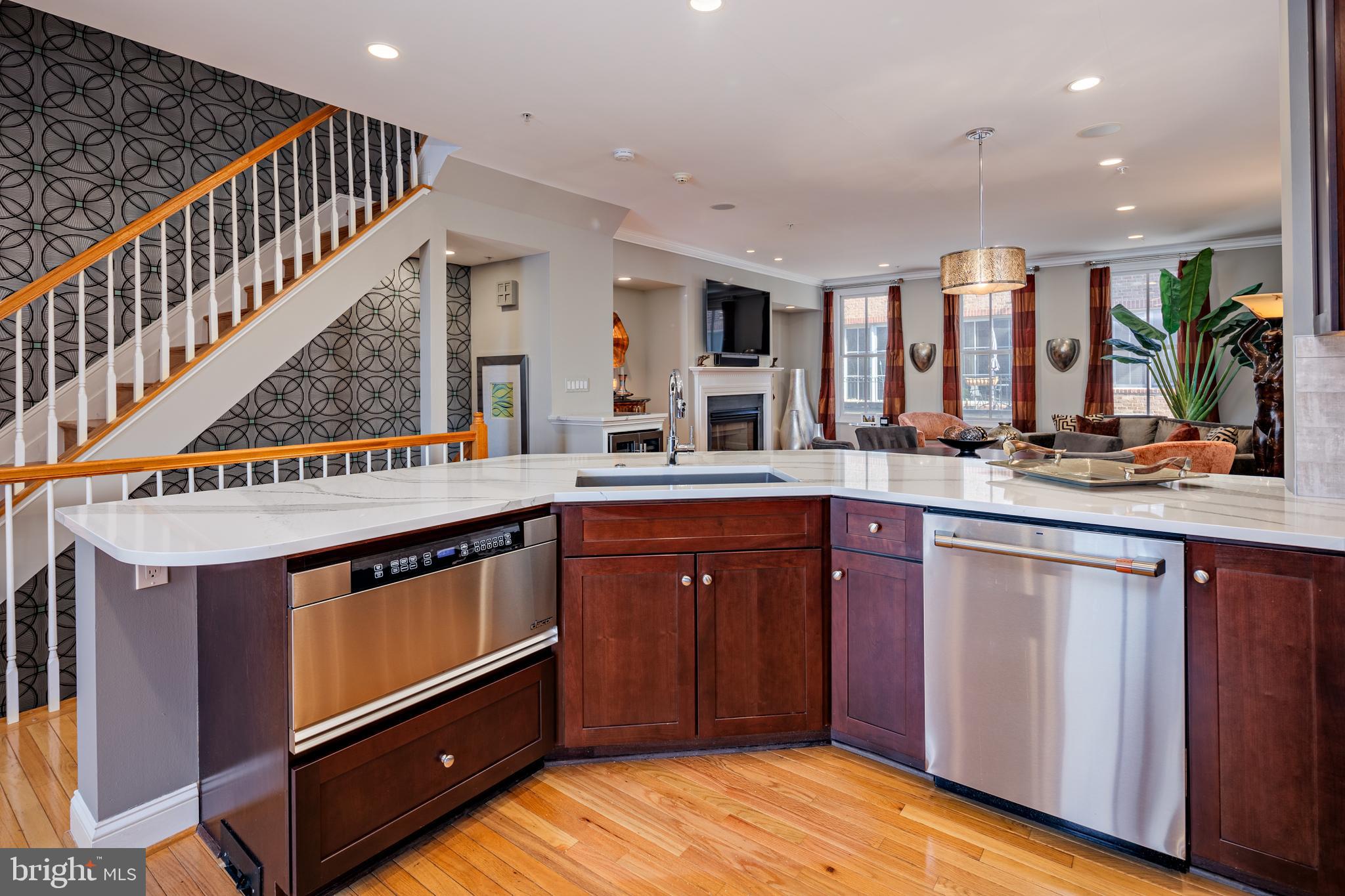 2317 Boston Street, Unit 3 Baltimore, MD 21224 - Photo 6 of 51 a kitchen with stainless steel appliances granite countertop a sink and a stove