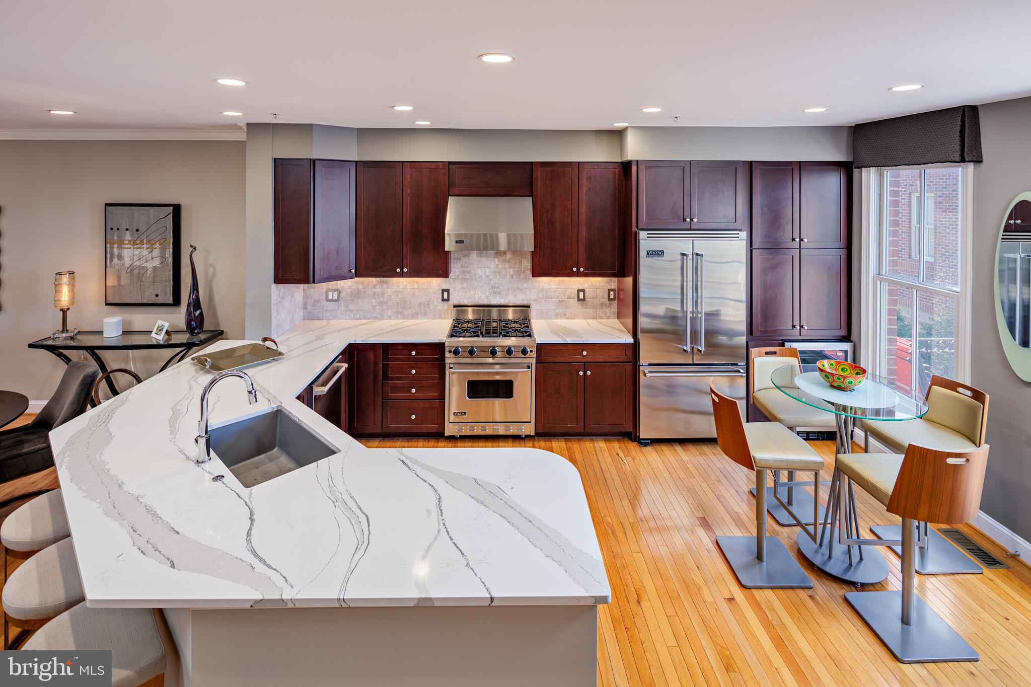 2317 Boston Street, Unit 3 Baltimore, MD 21224 - Photo 9 of 51 a kitchen with stainless steel appliances kitchen island granite countertop a stove a sink a refrigerator and a microwave