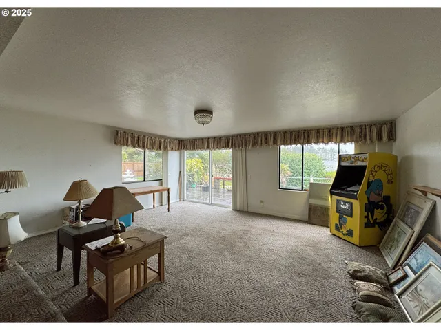 a living room with furniture a window and gym equipment