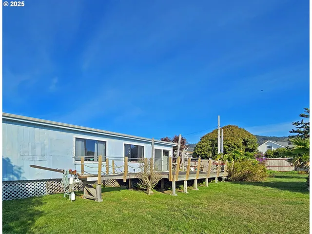 a view of a house with backyard porch and sitting area