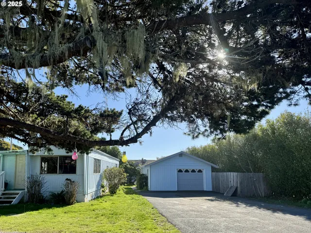 a view of a yard with wooden fence