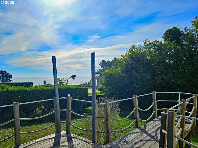 a wooden fence with some trees in the background