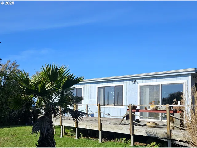 a view of a house with backyard sitting area and garden