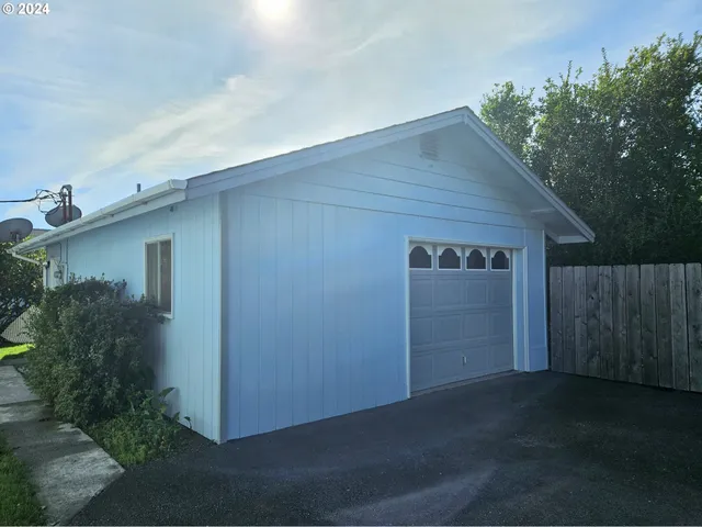 a backyard of a house with plants and trees