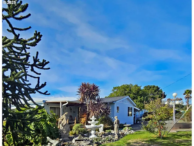 a view of house with a yard and a tree