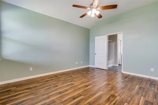 a bedroom with a bed and a potted plant