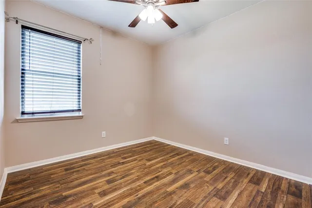 a view of room with wooden floor