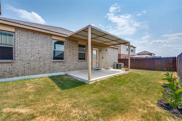 a view of a backyard with fence