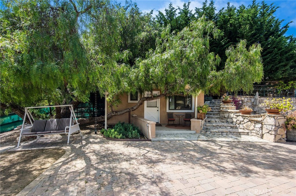 1 Thyme Place Rancho Palos Verdes, CA 90275 - Photo 11 of 35 a view of a patio with table and chairs and potted plants with large tree