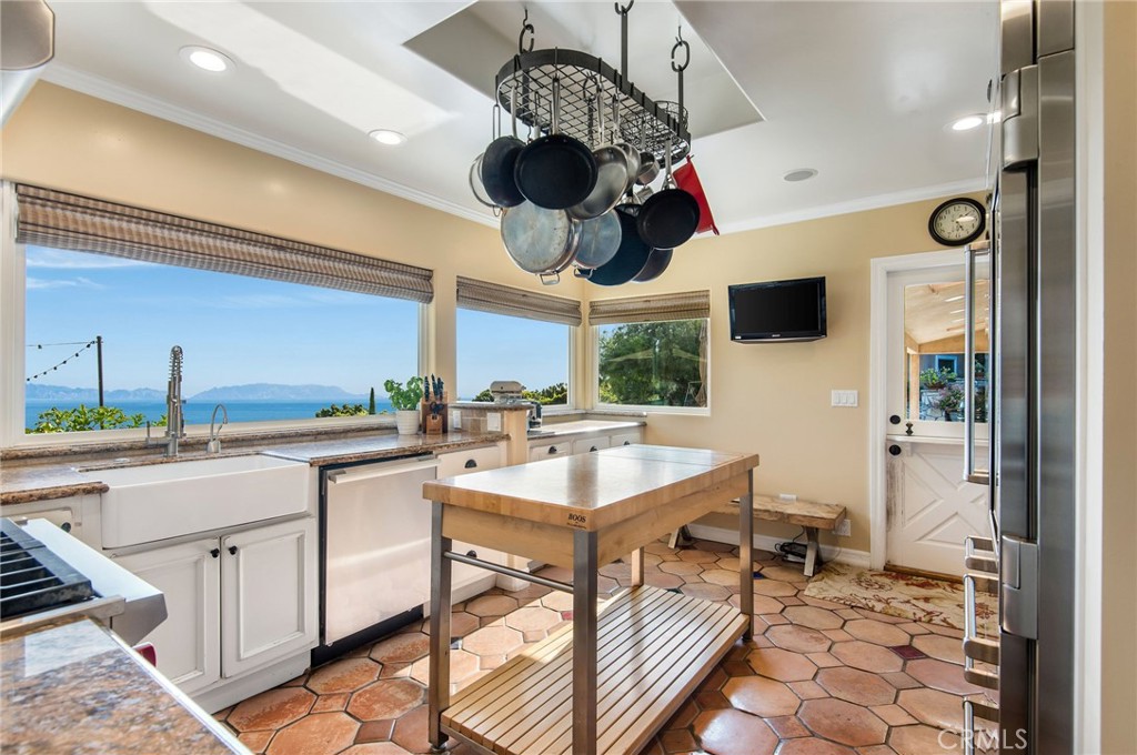 1 Thyme Place Rancho Palos Verdes, CA 90275 - Photo 23 of 35 a kitchen with a sink a stove cabinets and living room view