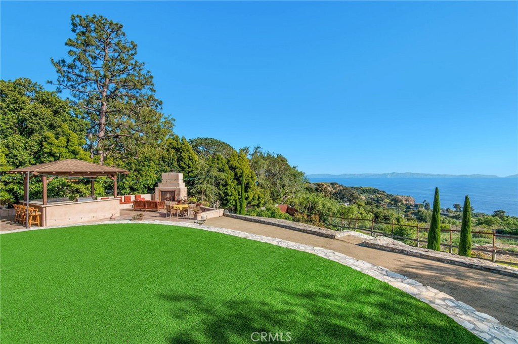 1 Thyme Place Rancho Palos Verdes, CA 90275 - Photo 26 of 35 a view of a patio with table and chairs under an umbrella