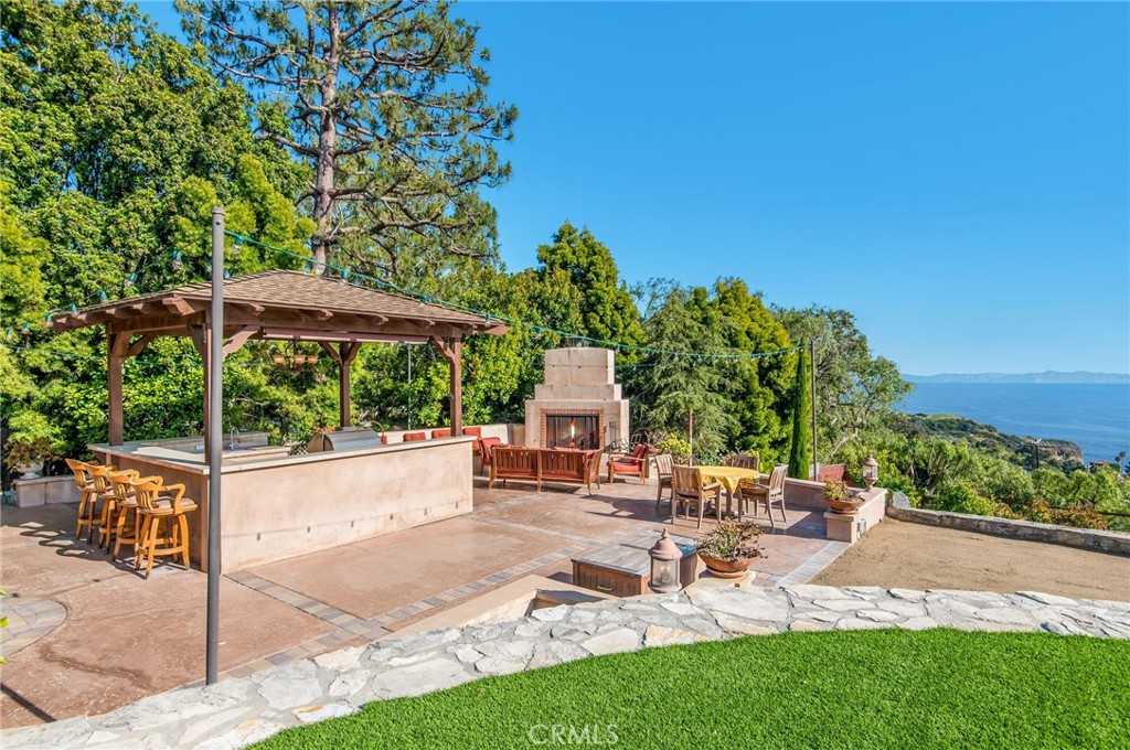 1 Thyme Place Rancho Palos Verdes, CA 90275 - Photo 27 of 35 a view of a patio with a table and chairs under an umbrella