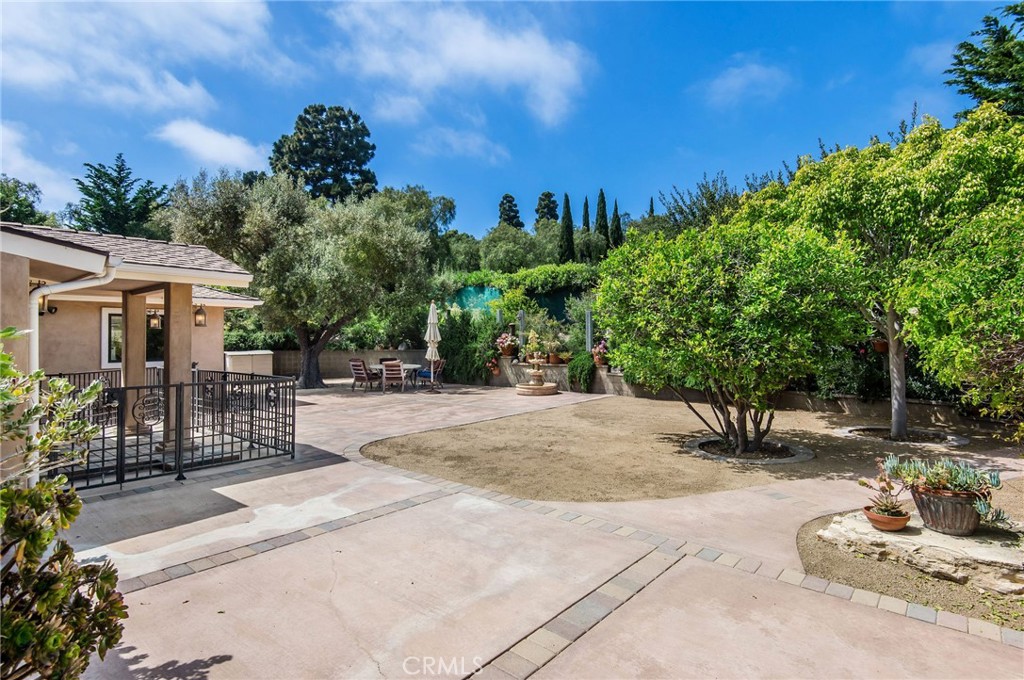 1 Thyme Place Rancho Palos Verdes, CA 90275 - Photo 5 of 35 a view of a patio with a table and chairs under an umbrella