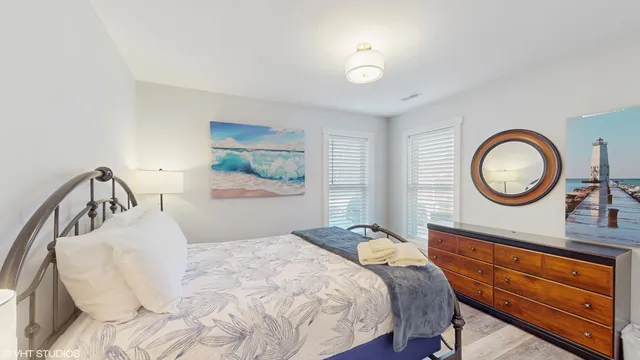 a bedroom with a bed and a chandelier