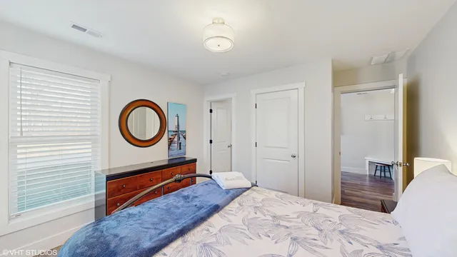 a bedroom with a bed and a chandelier