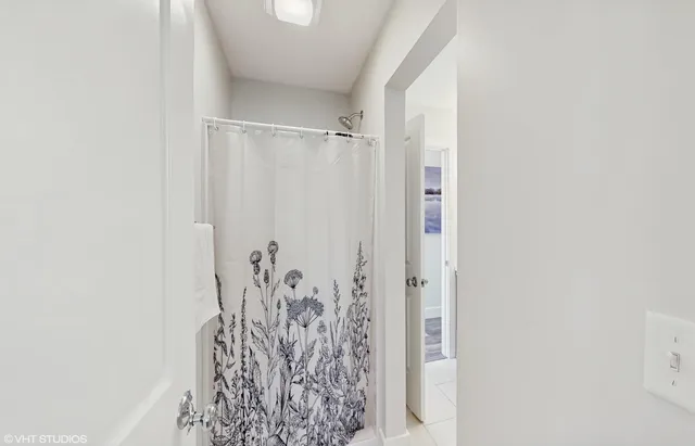 a bathroom with a shower curtain and a shower curtain