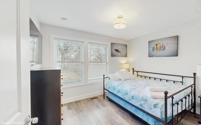 a bedroom with a bed and a flat screen tv