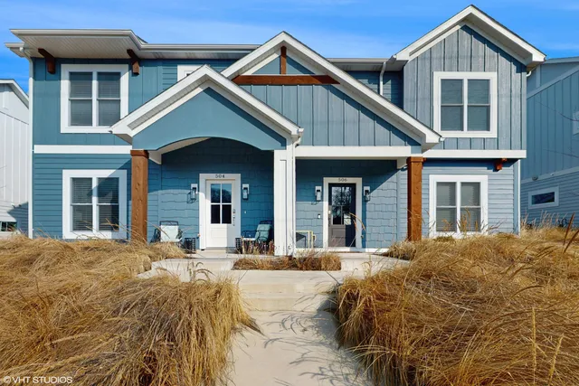 a view of a house with large windows and a outdoor space