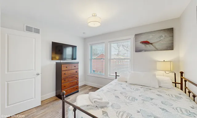 a bedroom with a bed and a large window