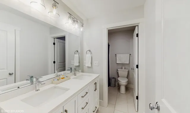 a bathroom with a shower curtain a sink and a mirror
