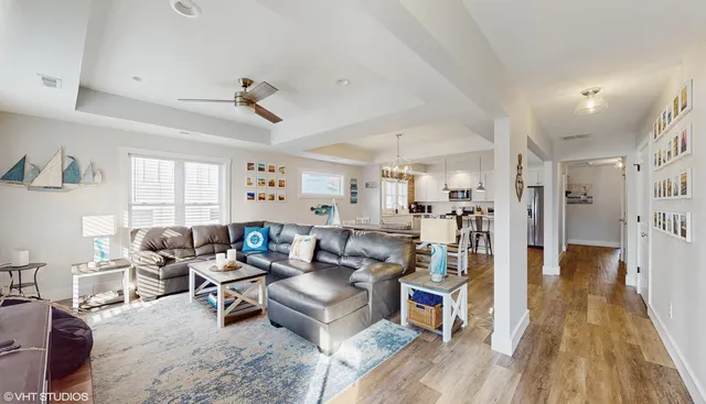 a living room with lots of furniture and wooden floors