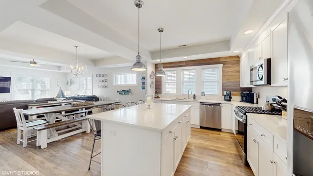 a kitchen with a stove a sink and a refrigerator