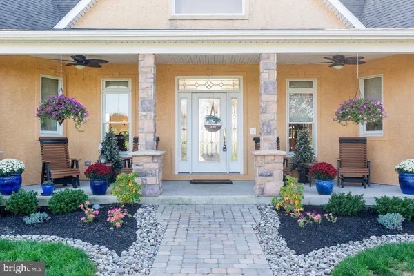a front view of a house with outdoor seating