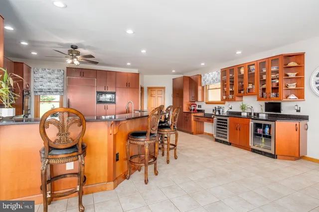 a kitchen with stainless steel appliances granite countertop a sink counter space cabinets and a large window