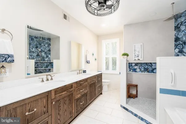 a bathroom with a sink vanity granite and toilet