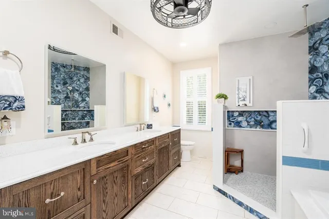 a bathroom with a sink vanity granite and toilet