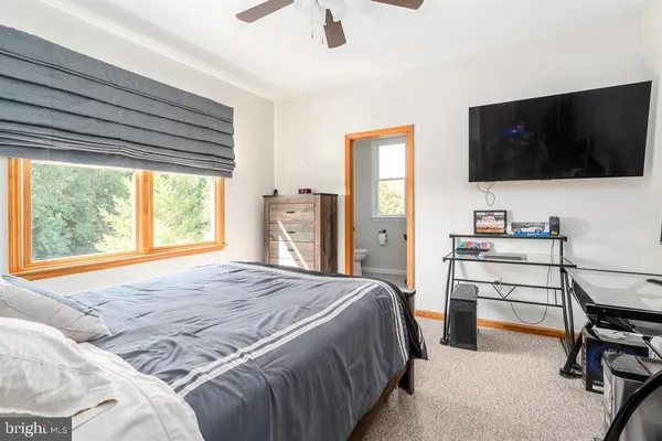 a spacious bedroom with a bed and a chandelier