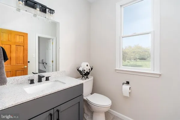 a bathroom with a sink a mirror and a shower