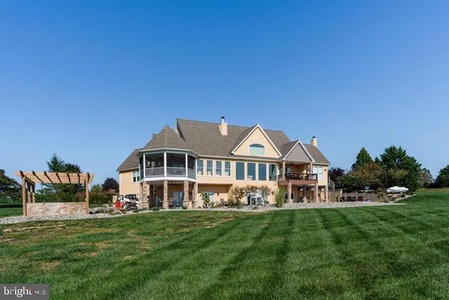 a front view of a house with a garden and trees