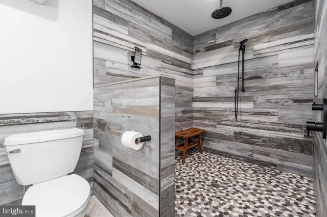 an aerial view of a residential houses with outdoor space and lake view