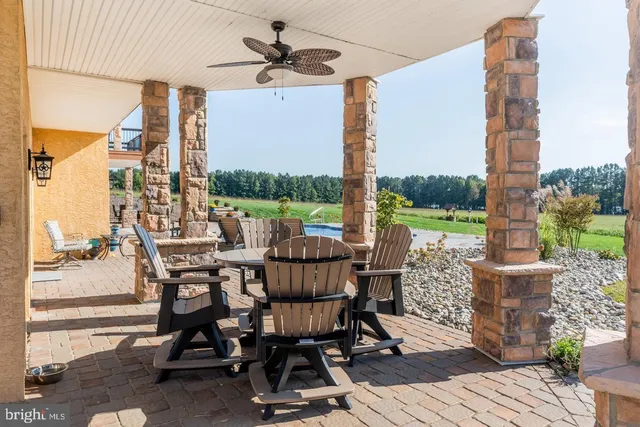 a view of a house with a big yard and large trees