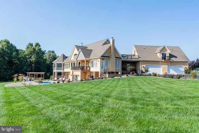 a front view of a house with a yard table and chairs