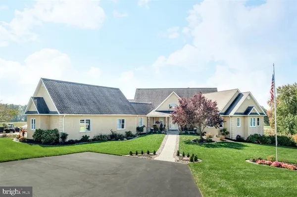 a front view of house with yard and green space