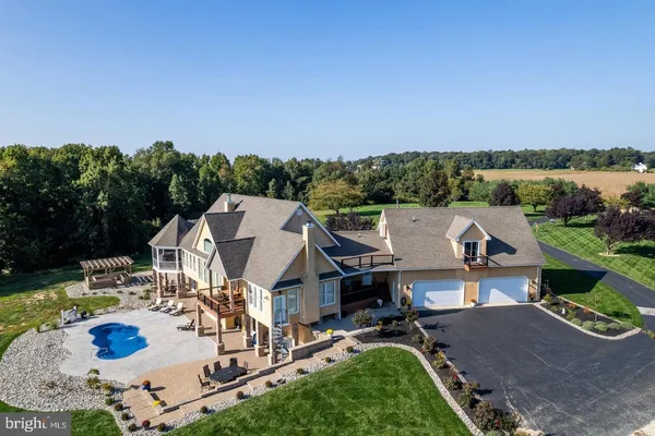 an aerial view of a house with yard swimming pool and outdoor seating