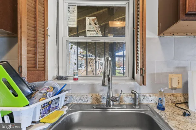 a kitchen with a sink and a wooden floor