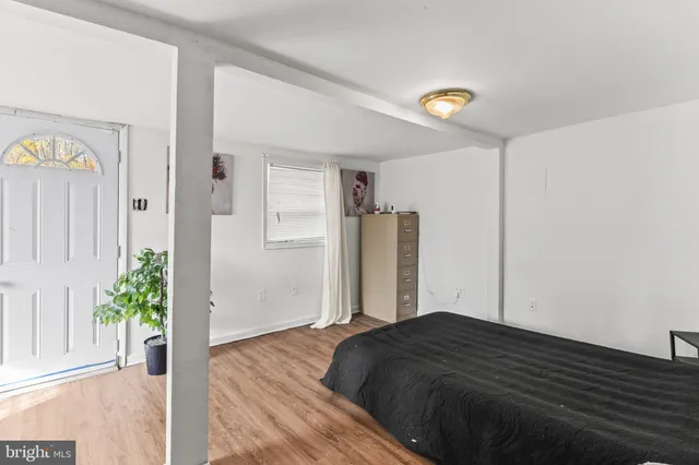 a bedroom with a bed and a potted plant