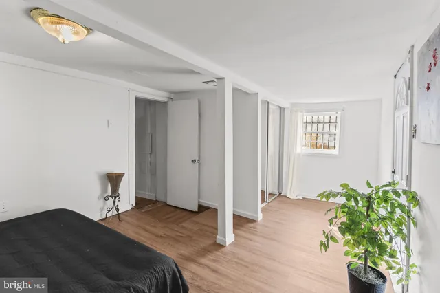 a bedroom with a bed and a potted plant