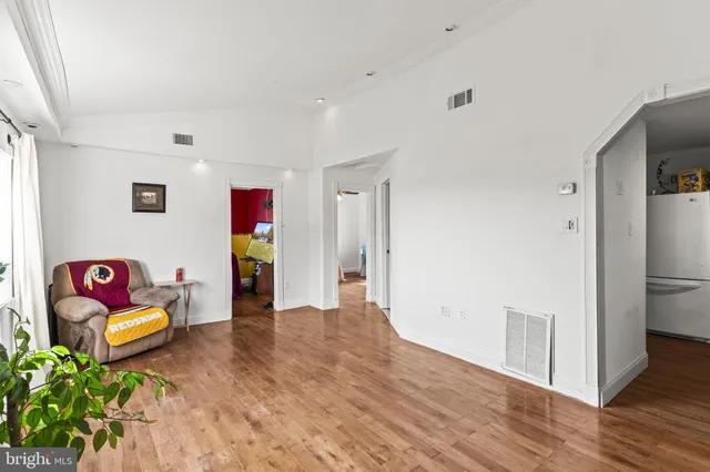 a view of a hallway with couch and wooden floor