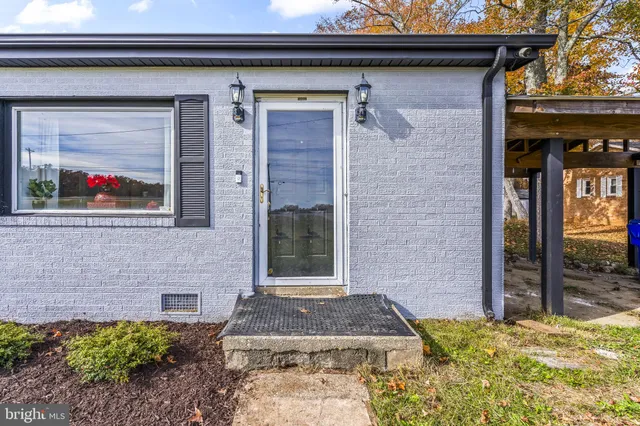 a view of a house with a backyard and a tree
