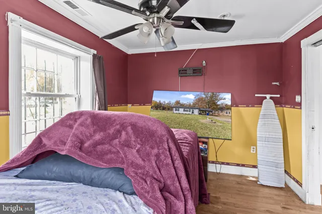 a bed sitting in a room next to a window