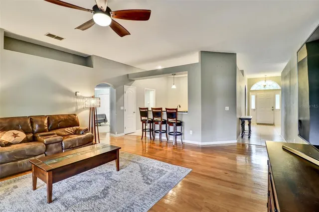 a living room with furniture and a dining table