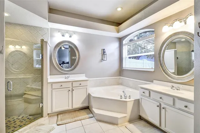 a bathroom with a sink mirror vanity and bathtub