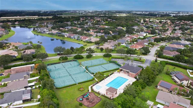 an aerial view of residential houses with outdoor space and river