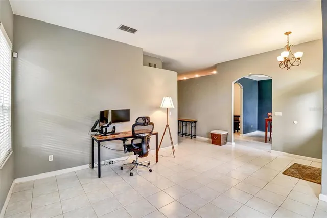 a view of a workspace with furniture and a window