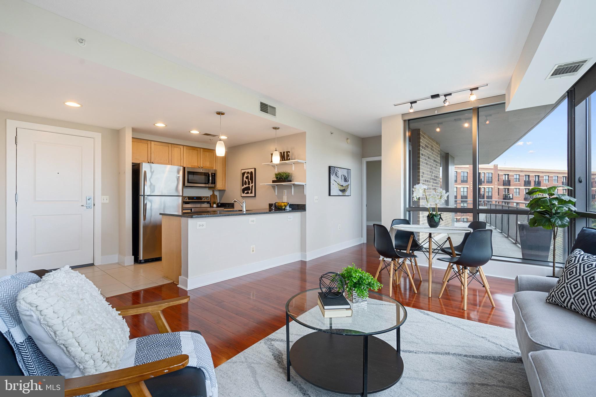2001 15th Street North, Unit 306 Arlington, VA 22201 - Photo 17 of 54 a living room with furniture kitchen and a table