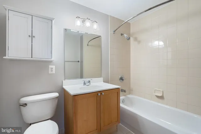 a bathroom with a sink toilet vanity and shower
